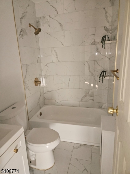 33 Glover Avenue Paterson, NJ 07501 - Photo 8 of 10 a bathroom with a toilet and a shower