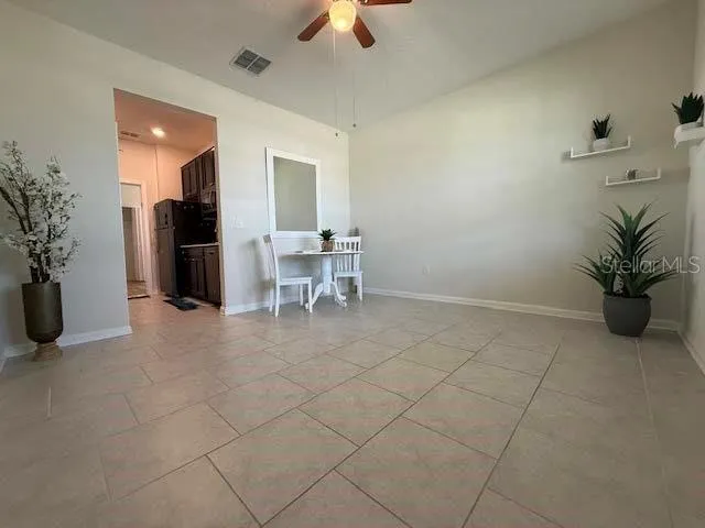 a view of a livingroom with furniture and a potted plant