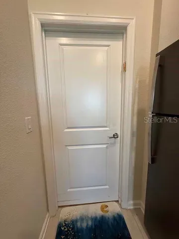 a view of storage and utility room with closet