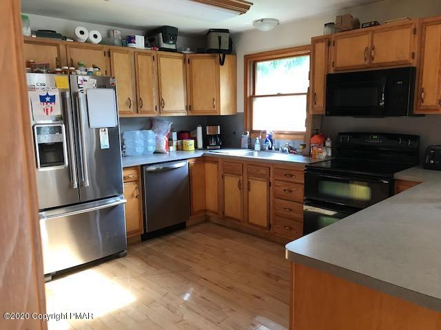 233 Shiffer Road Stroudsburg, PA 18360 - Photo 5 of 20 a kitchen with stainless steel appliances granite countertop a refrigerator sink and microwave