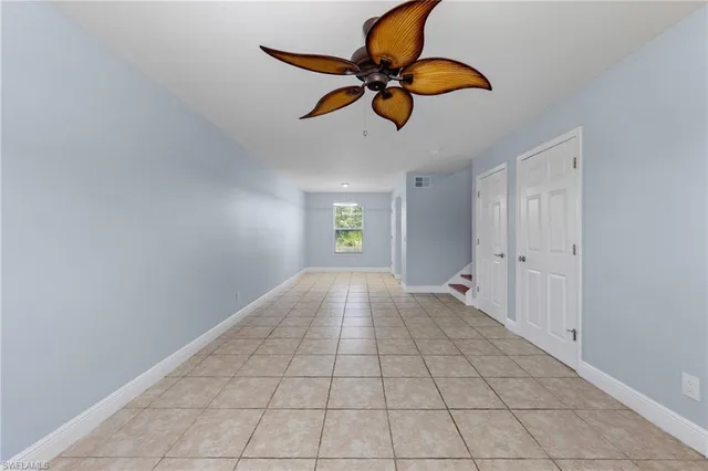 a view of an empty room and window and cabinet