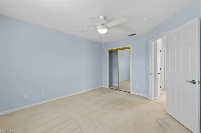 a view of an empty room with a ceiling fan