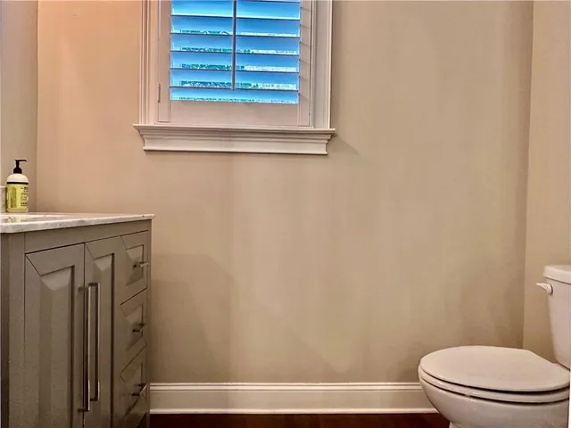 a bathroom with a toilet and a window