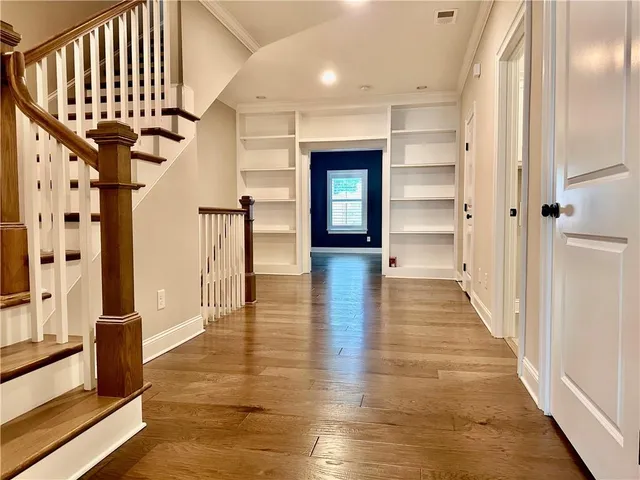 a view of an entryway with wooden floor