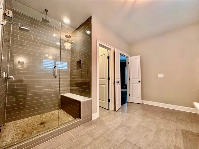 a bathroom with a shower and a mirror