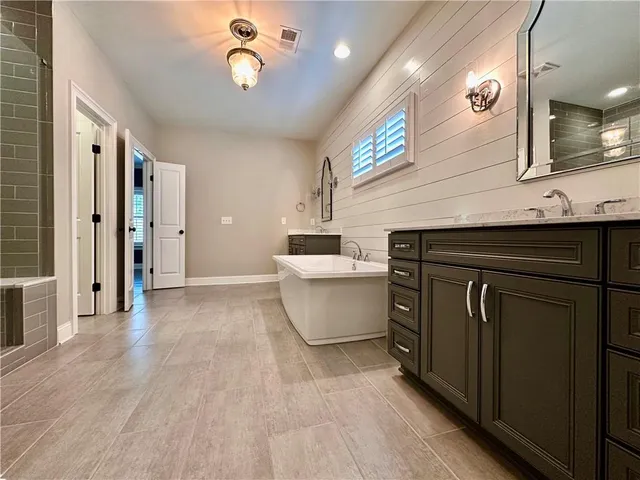 a kitchen with a sink cabinets and wooden floor