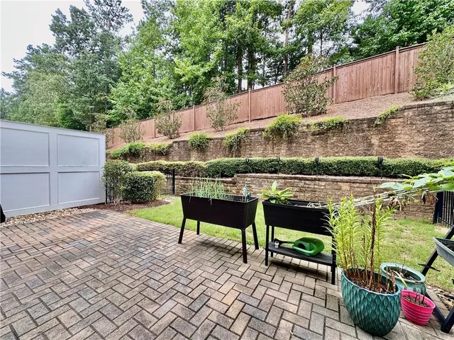 a backyard of a house with table and chairs