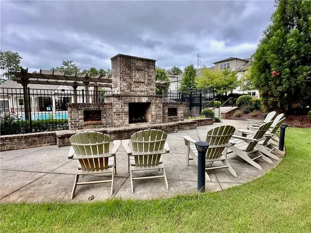 a view of a patio with dining table and chairs