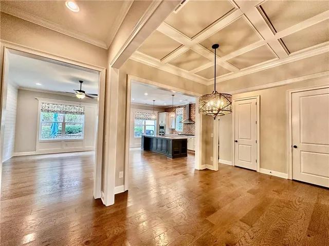 a view of a livingroom with wooden floor and a ceiling fan