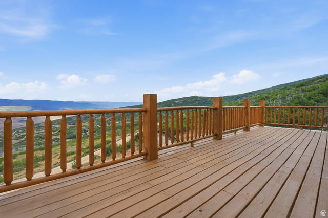 20 Q Puma Road Fairview, UT 84629 - Photo 21 of 27 Expansive wooden deck with natural wood railing and balusters, featuring open-air exposure and a mountainous landscape