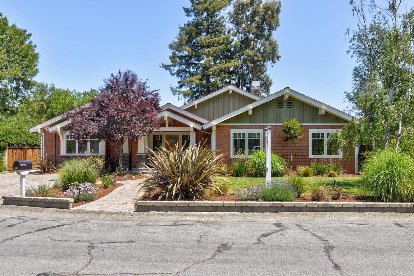 a front view of a house with a garden