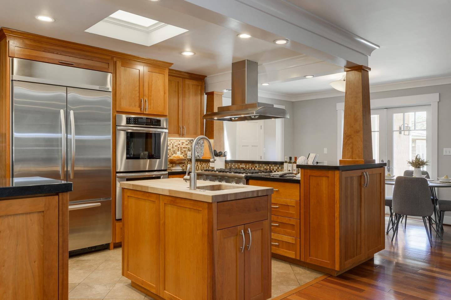 1035 Rilma Lane Los Altos, CA 94022 - Photo 11 of 41 a kitchen with stainless steel appliances granite countertop a sink a stove and a refrigerator