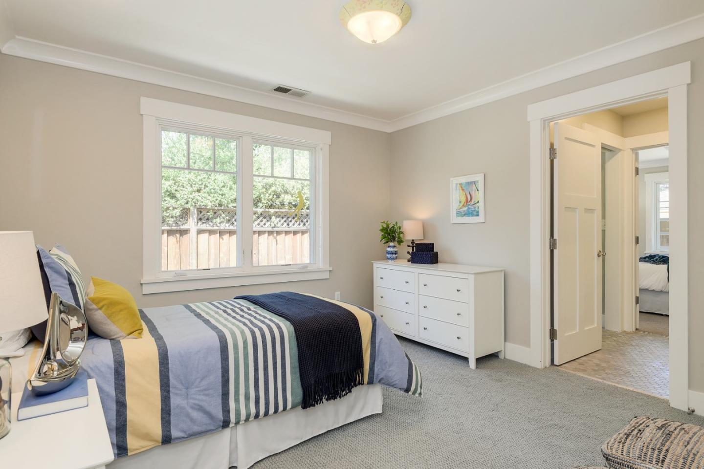 1035 Rilma Lane Los Altos, CA 94022 - Photo 18 of 41 a spacious bedroom with a bed and a dresser