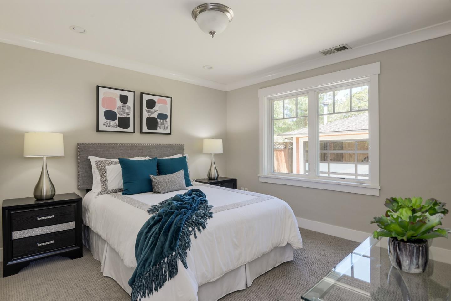 1035 Rilma Lane Los Altos, CA 94022 - Photo 22 of 41 a bedroom with a bed and a potted plant