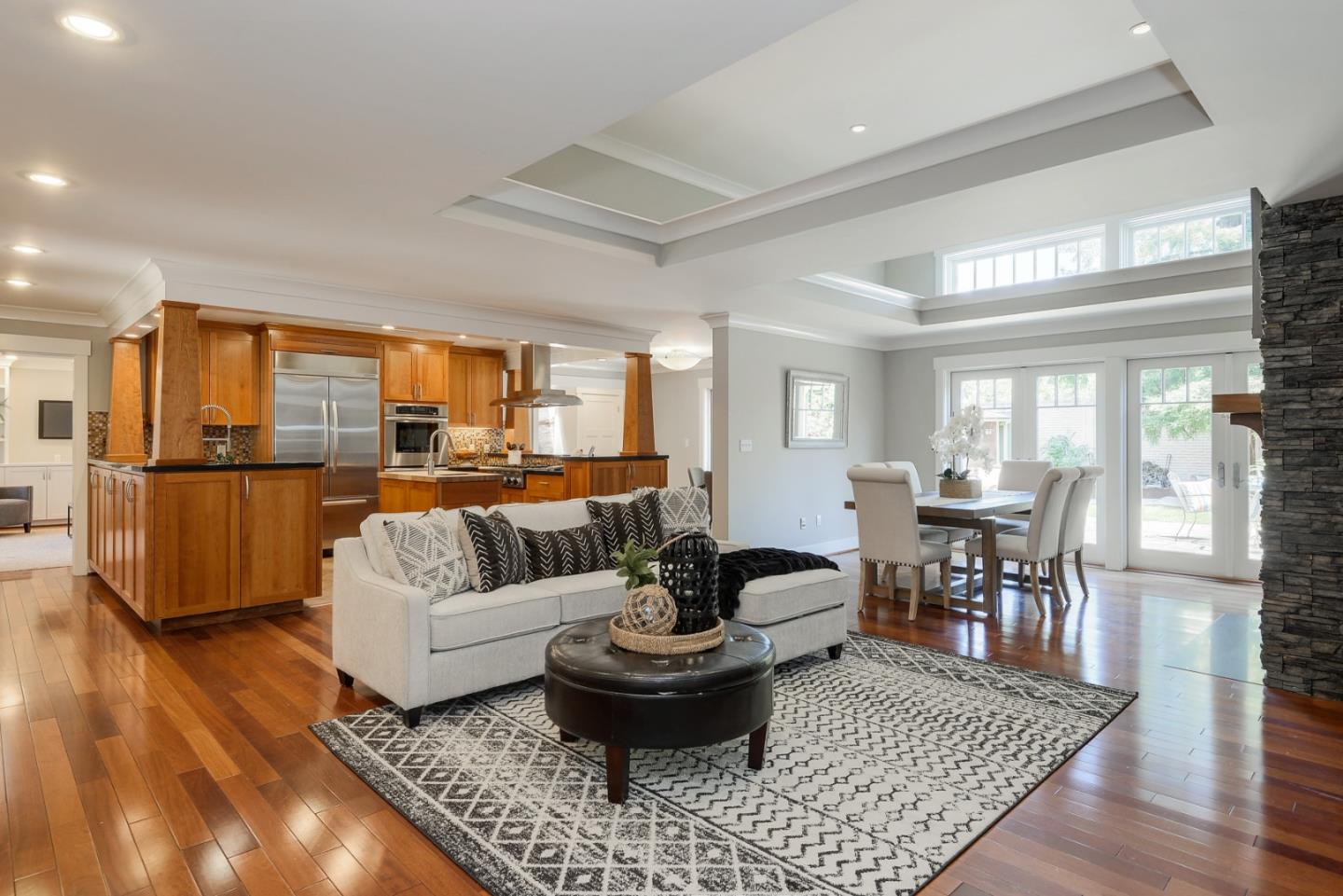 1035 Rilma Lane Los Altos, CA 94022 - Photo 4 of 41 a living room with furniture and a dining table with wooden floor