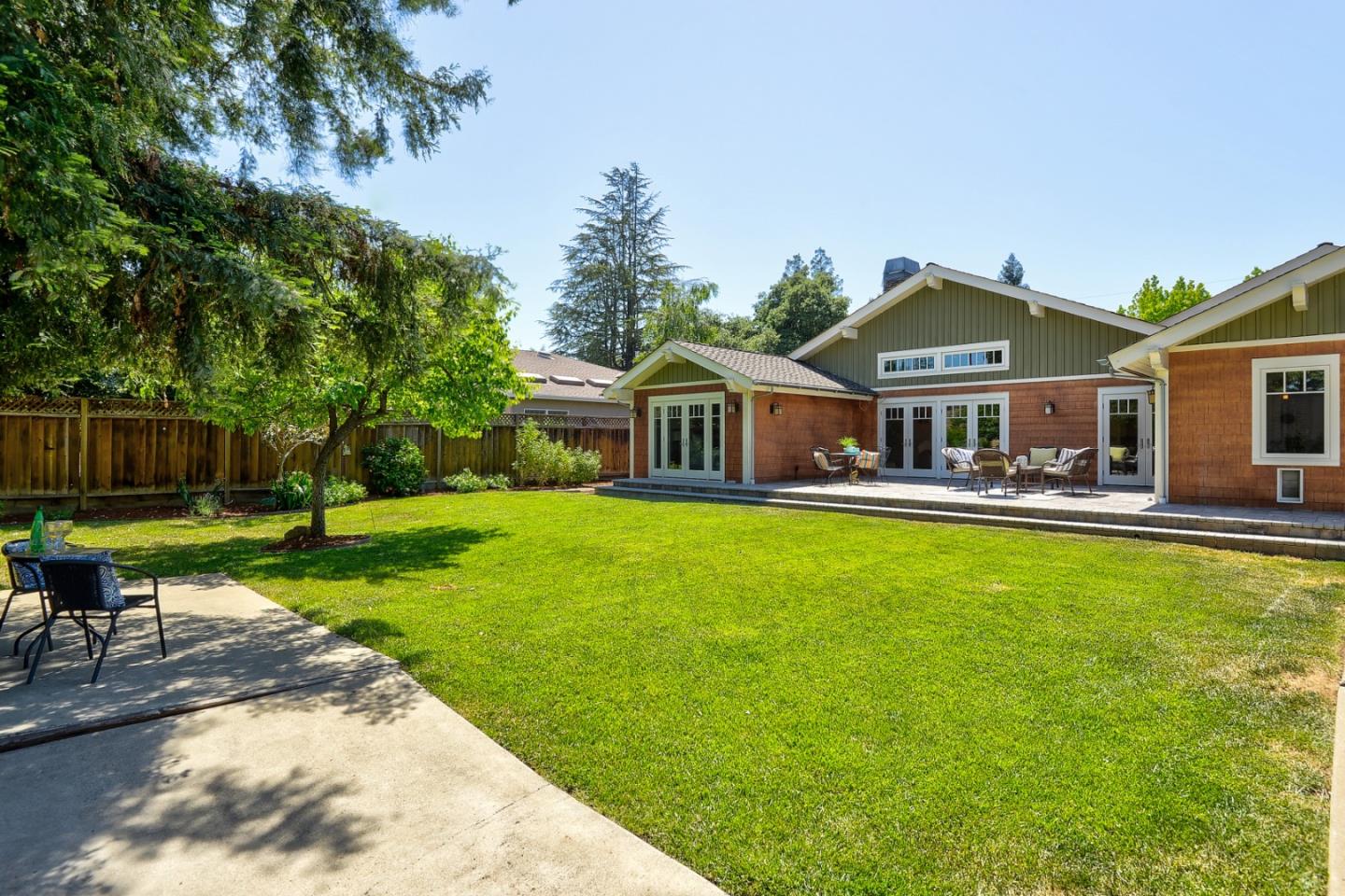 1035 Rilma Lane Los Altos, CA 94022 - Photo 36 of 41 a front view of a house with a yard table and chairs
