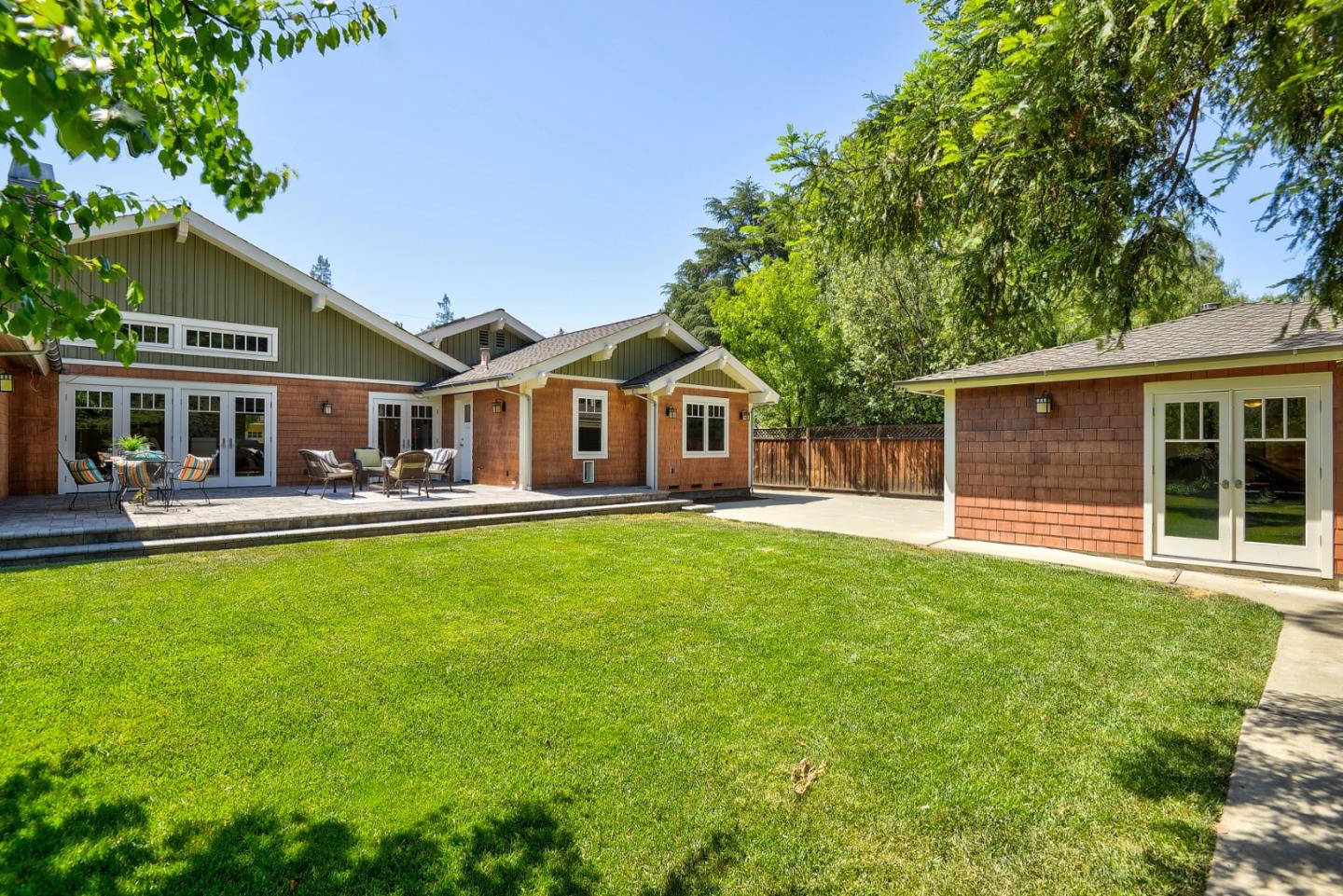 1035 Rilma Lane Los Altos, CA 94022 - Photo 37 of 41 a front view of a house with a yard table and chairs