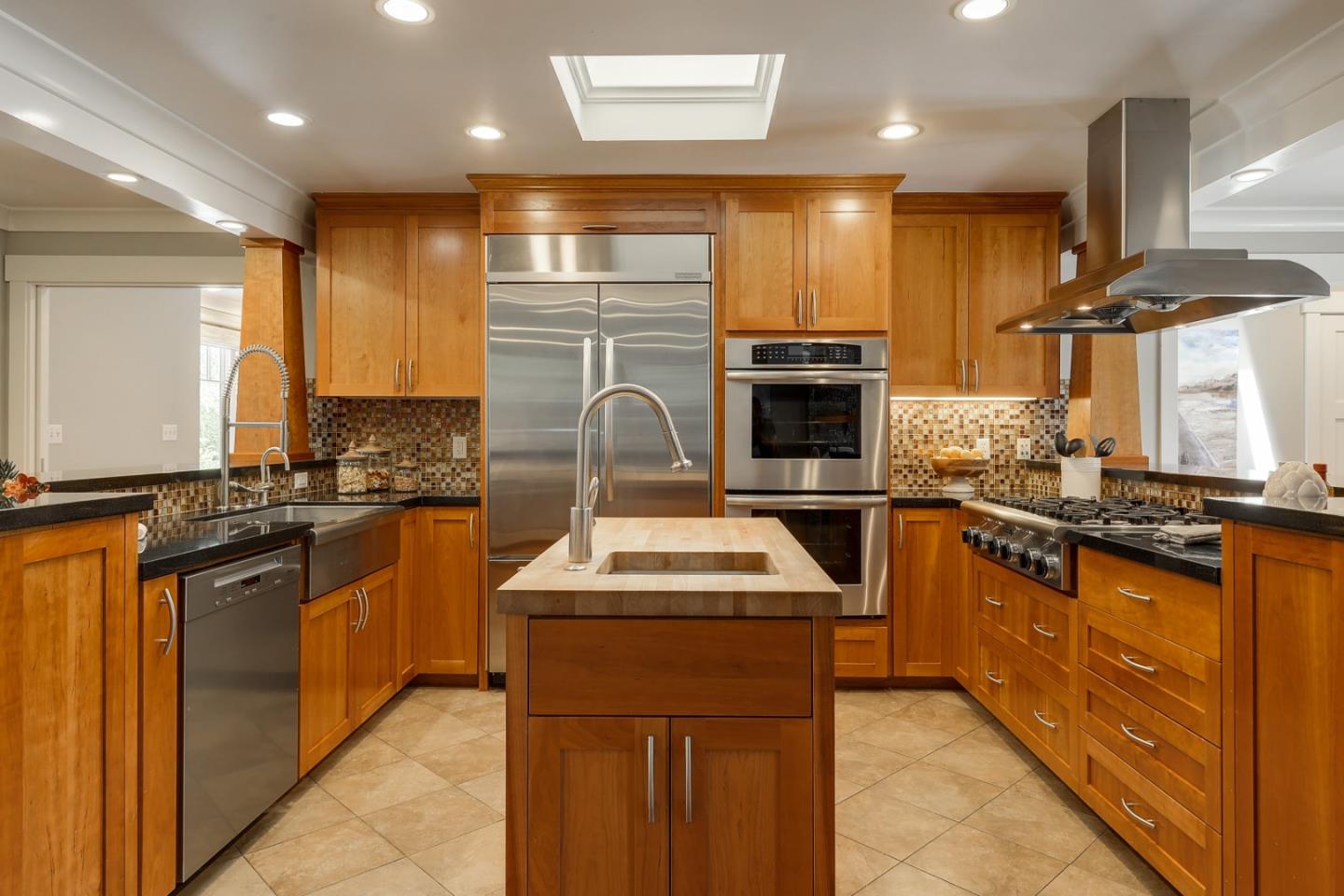1035 Rilma Lane Los Altos, CA 94022 - Photo 9 of 41 a kitchen with stainless steel appliances granite countertop a sink stove and refrigerator