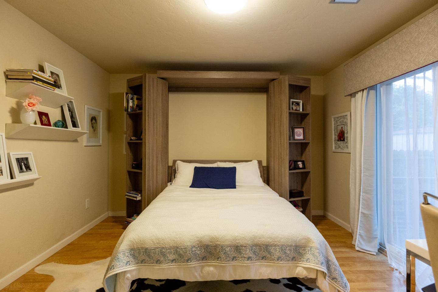 779 Alice Street Monterey, CA 93940 - Photo 17 of 27 a bedroom with a bed and wooden floor