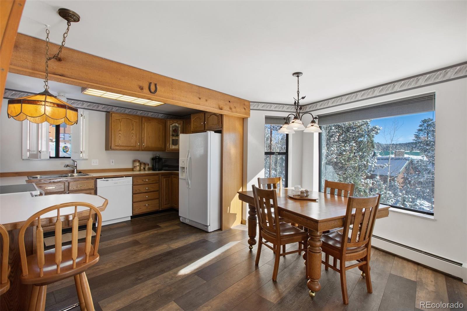 170 Ridge Road Divide, CO 80814 - Photo 15 of 50 a dining room with furniture a chandelier and wooden floor