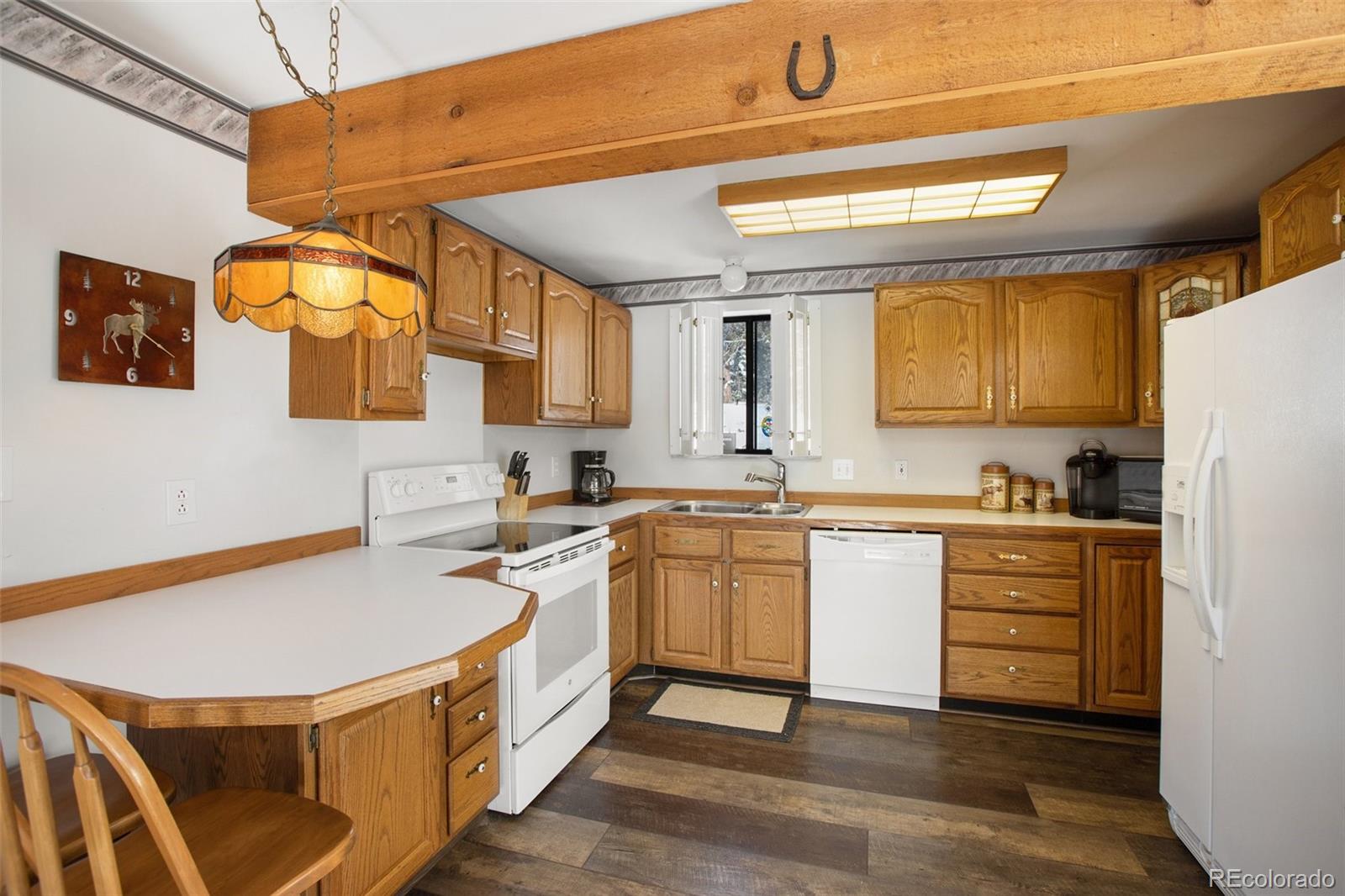 170 Ridge Road Divide, CO 80814 - Photo 18 of 50 a kitchen with stainless steel appliances granite countertop a sink and cabinets