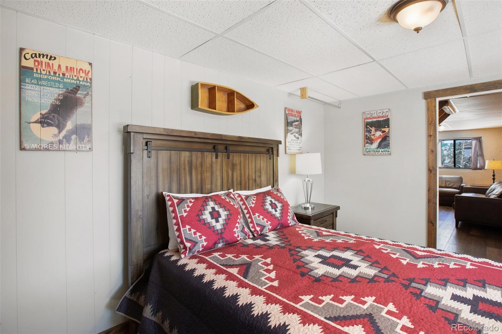 170 Ridge Road Divide, CO 80814 - Photo 29 of 50 a bedroom with a bed and painting on the wall