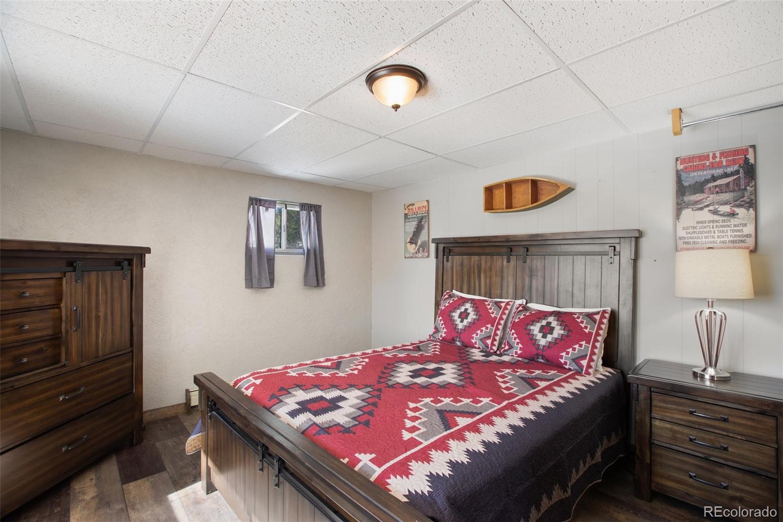 170 Ridge Road Divide, CO 80814 - Photo 30 of 50 a bedroom with a bed and wooden floor