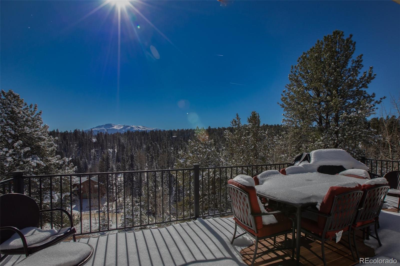 170 Ridge Road Divide, CO 80814 - Photo 38 of 50 a view of a roof deck with table and chairs with wooden floor and fence