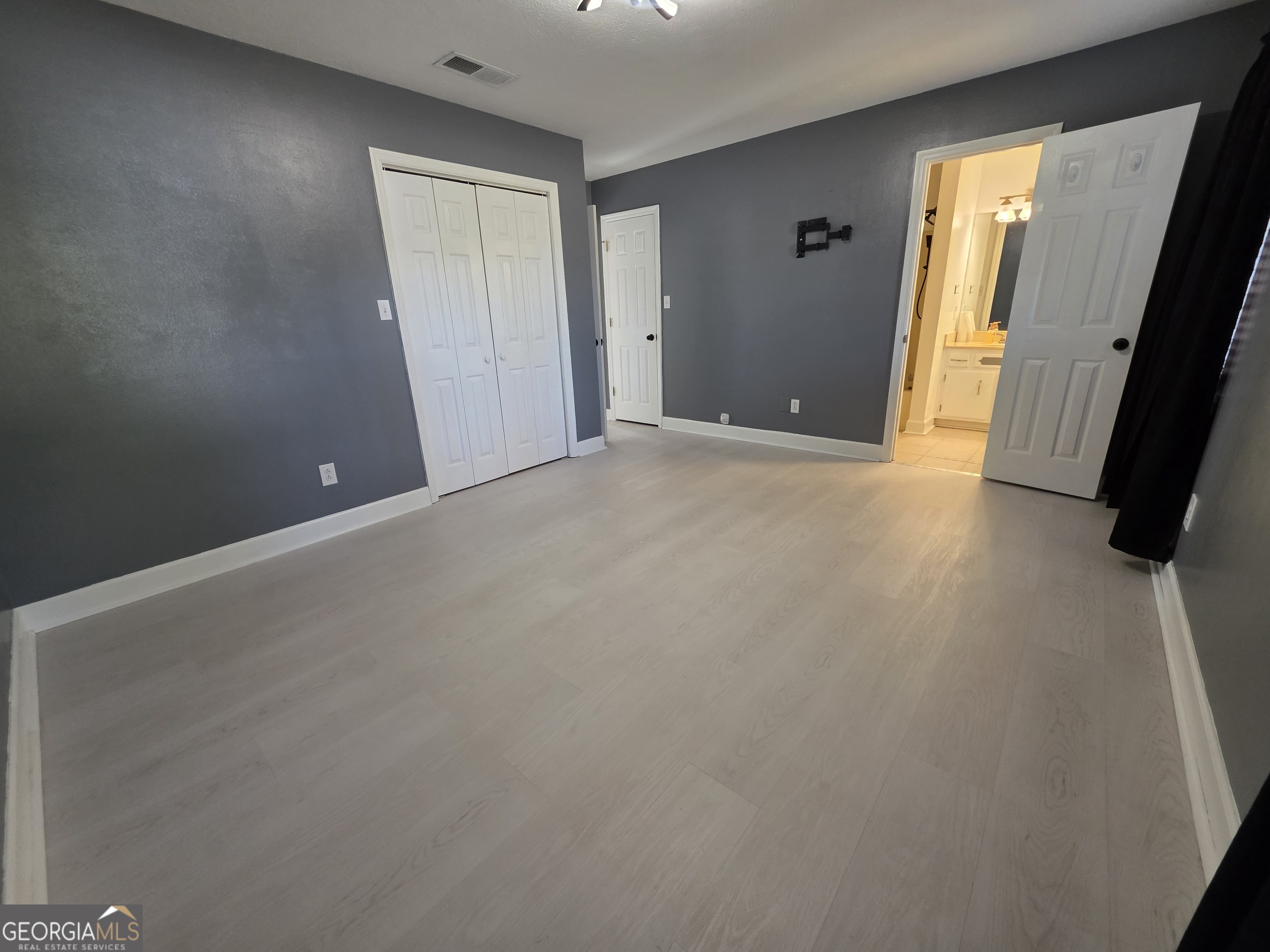 110 Maggie Court Leesburg, GA 31763 - Photo 23 of 64 an empty room with walk in closet and wooden floor