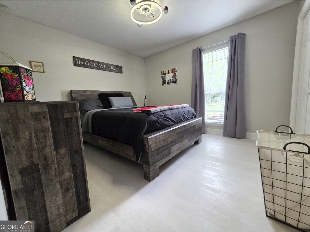 110 Maggie Court Leesburg, GA 31763 - Photo 46 of 64 a spacious bedroom with a bed and window
