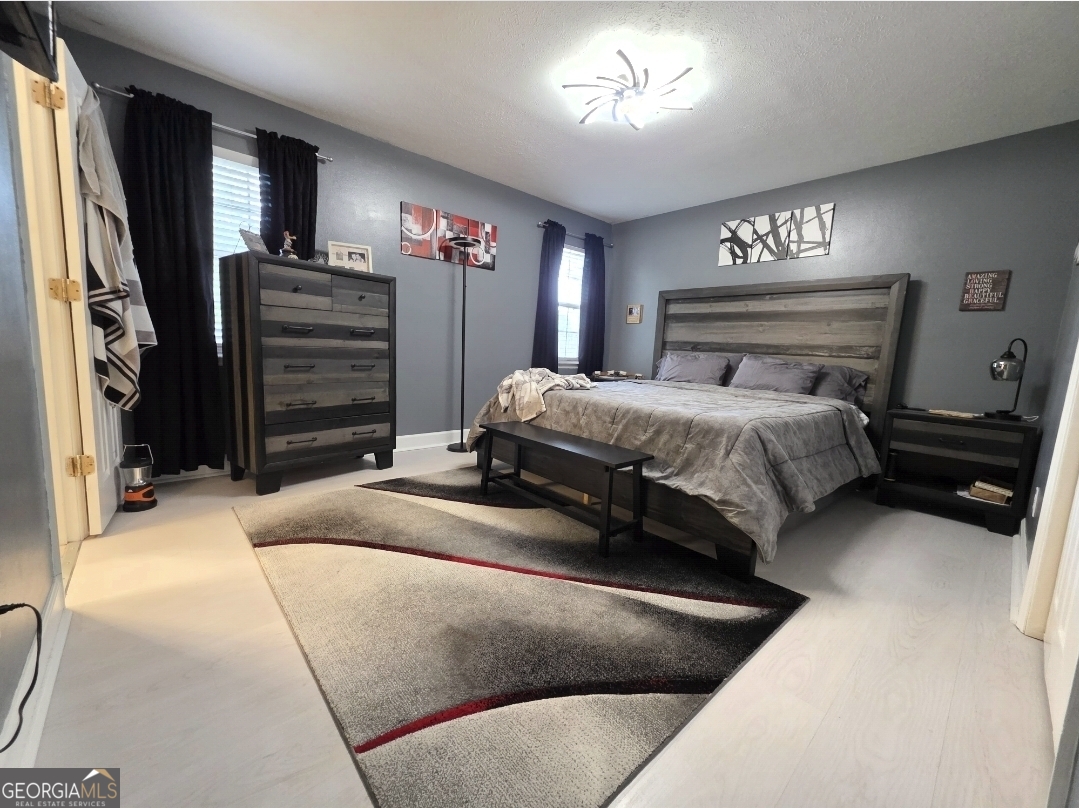 110 Maggie Court Leesburg, GA 31763 - Photo 50 of 64 a bedroom with a bed and a chandelier