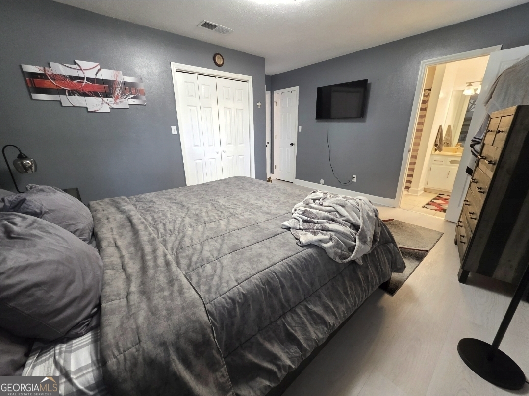 110 Maggie Court Leesburg, GA 31763 - Photo 51 of 64 a bedroom with a bed and a flat screen tv
