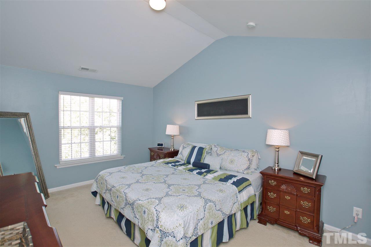 2161 Metacomet Way Raleigh, NC 27604 - Photo 11 of 21 a bedroom with a bed and a lamp on dresser