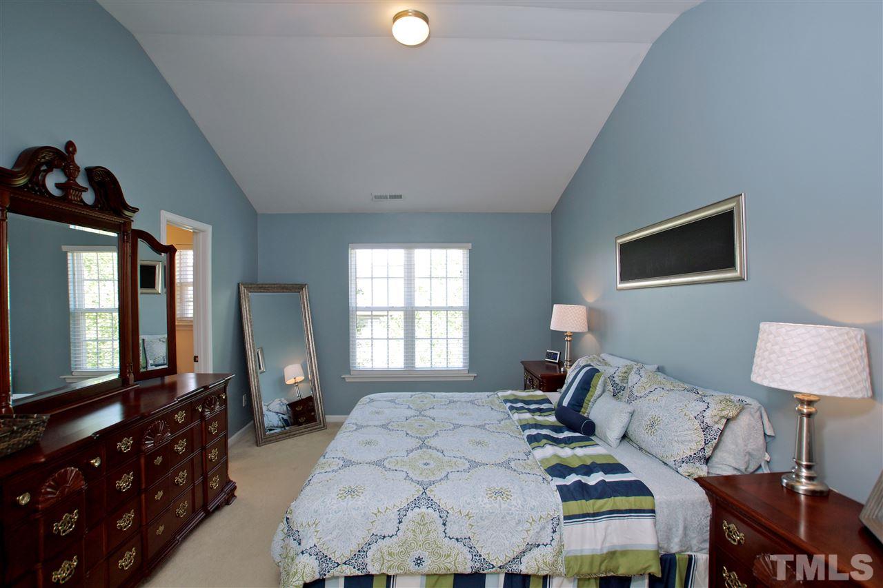 2161 Metacomet Way Raleigh, NC 27604 - Photo 12 of 21 a bedroom with a bed a dresser and flat screen tv