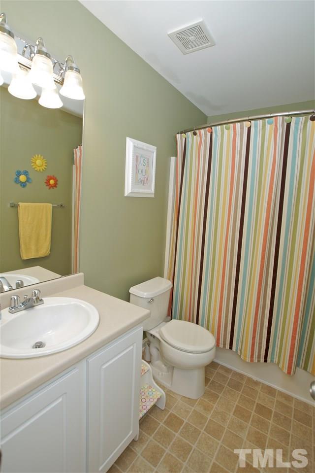 2161 Metacomet Way Raleigh, NC 27604 - Photo 18 of 21 a bathroom with a sink a toilet and shower curtain