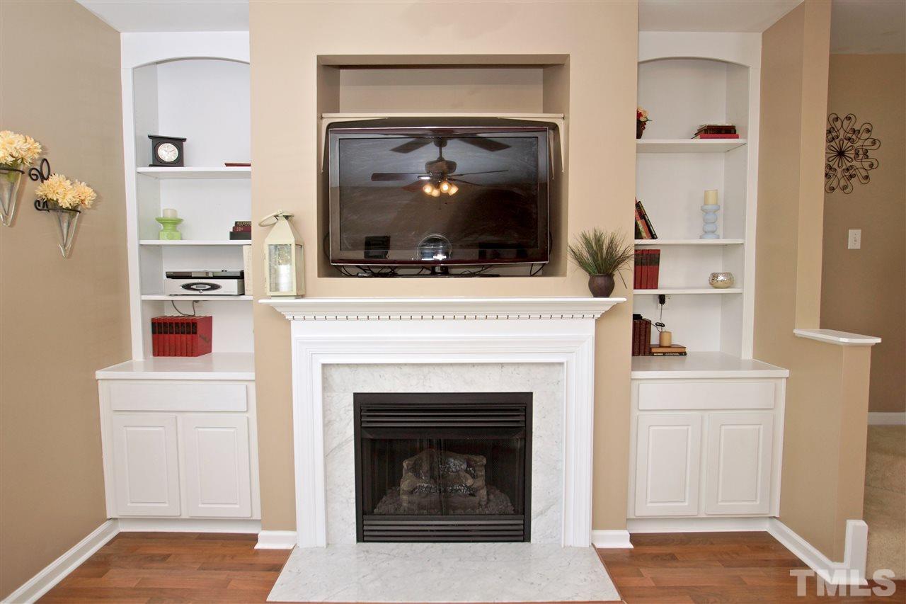 2161 Metacomet Way Raleigh, NC 27604 - Photo 4 of 21 a living room with a fireplace and a flat screen tv