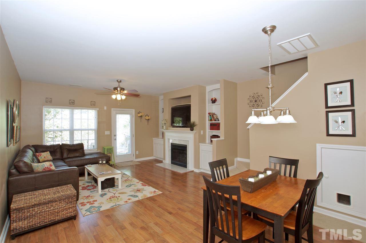 2161 Metacomet Way Raleigh, NC 27604 - Photo 5 of 21 a living room with furniture a fireplace and a flat screen tv