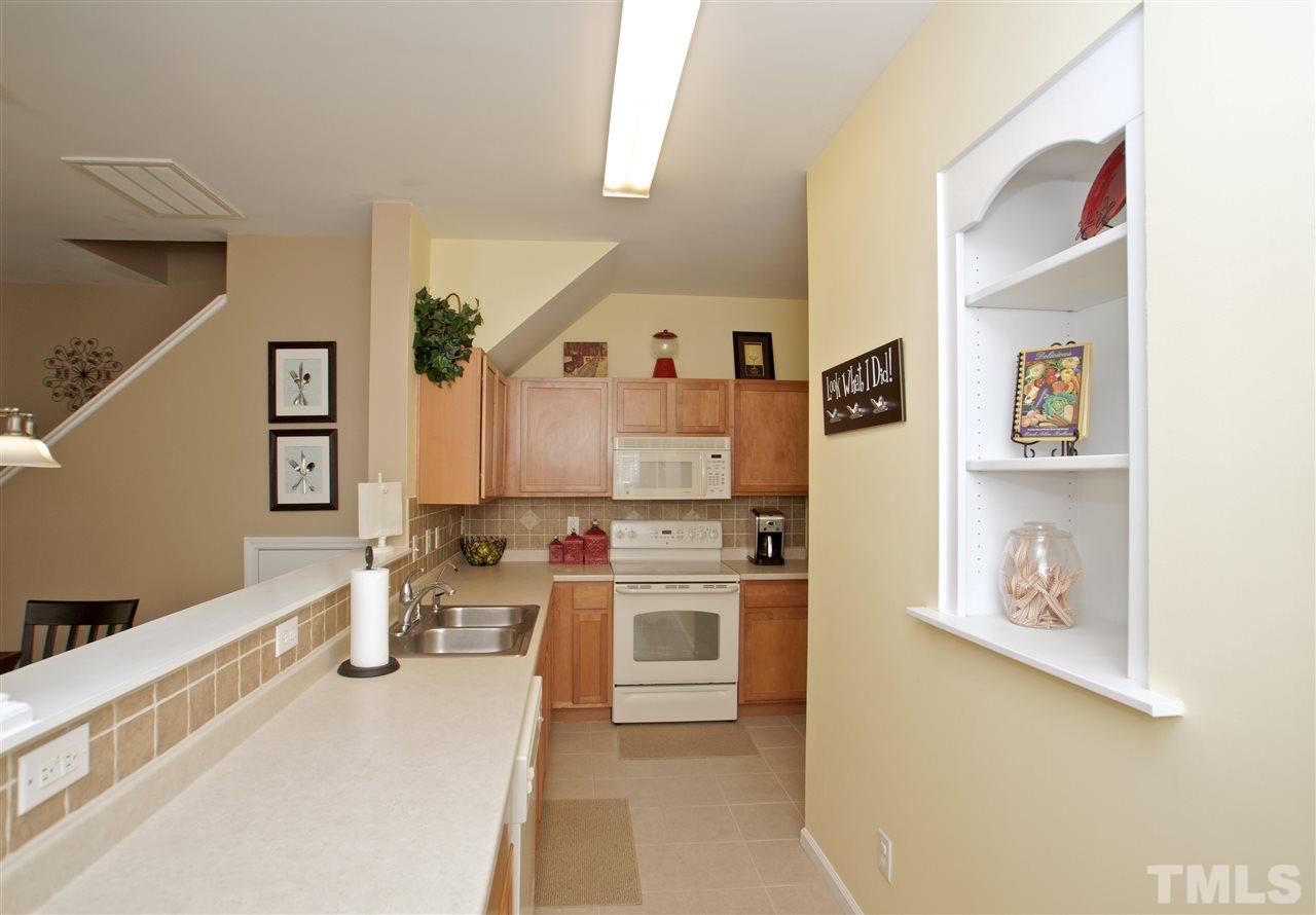 2161 Metacomet Way Raleigh, NC 27604 - Photo 8 of 21 a kitchen with stainless steel appliances a stove a sink and a refrigerator
