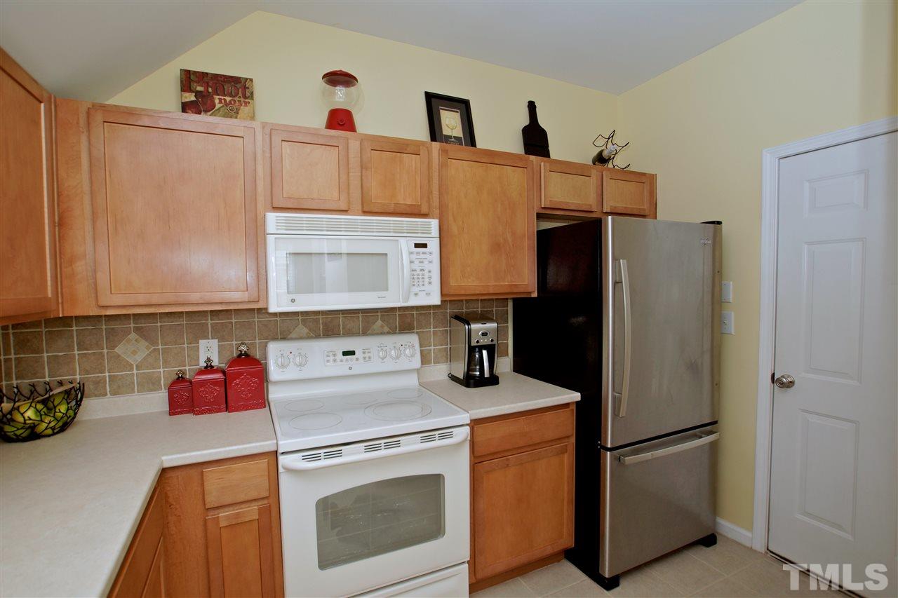 2161 Metacomet Way Raleigh, NC 27604 - Photo 9 of 21 a kitchen with refrigerator and cabinets