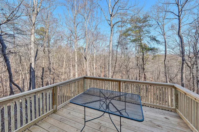 a view of a balcony with wooden floor and fence