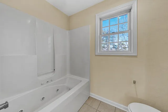 a bathroom with a bathtub and toilet