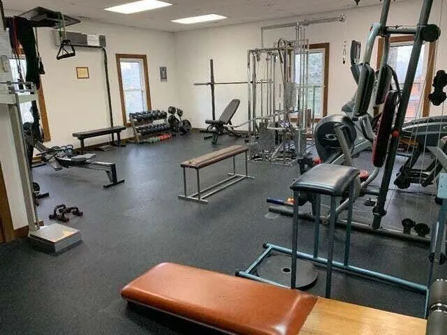 a room with gym equipment and a large window