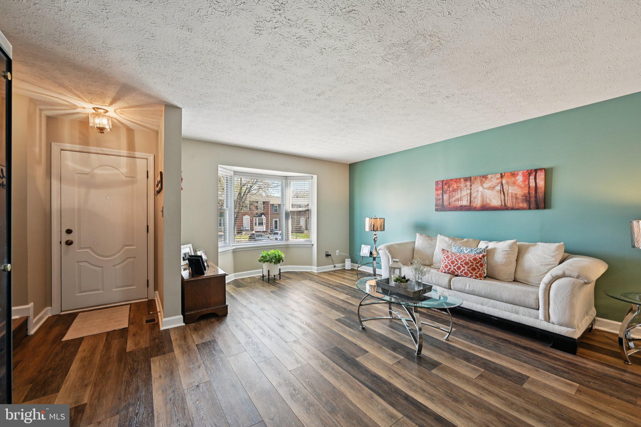 46 Bellfalls Way Baltimore, MD 21236 - Photo 11 of 65 a living room with furniture and a gate