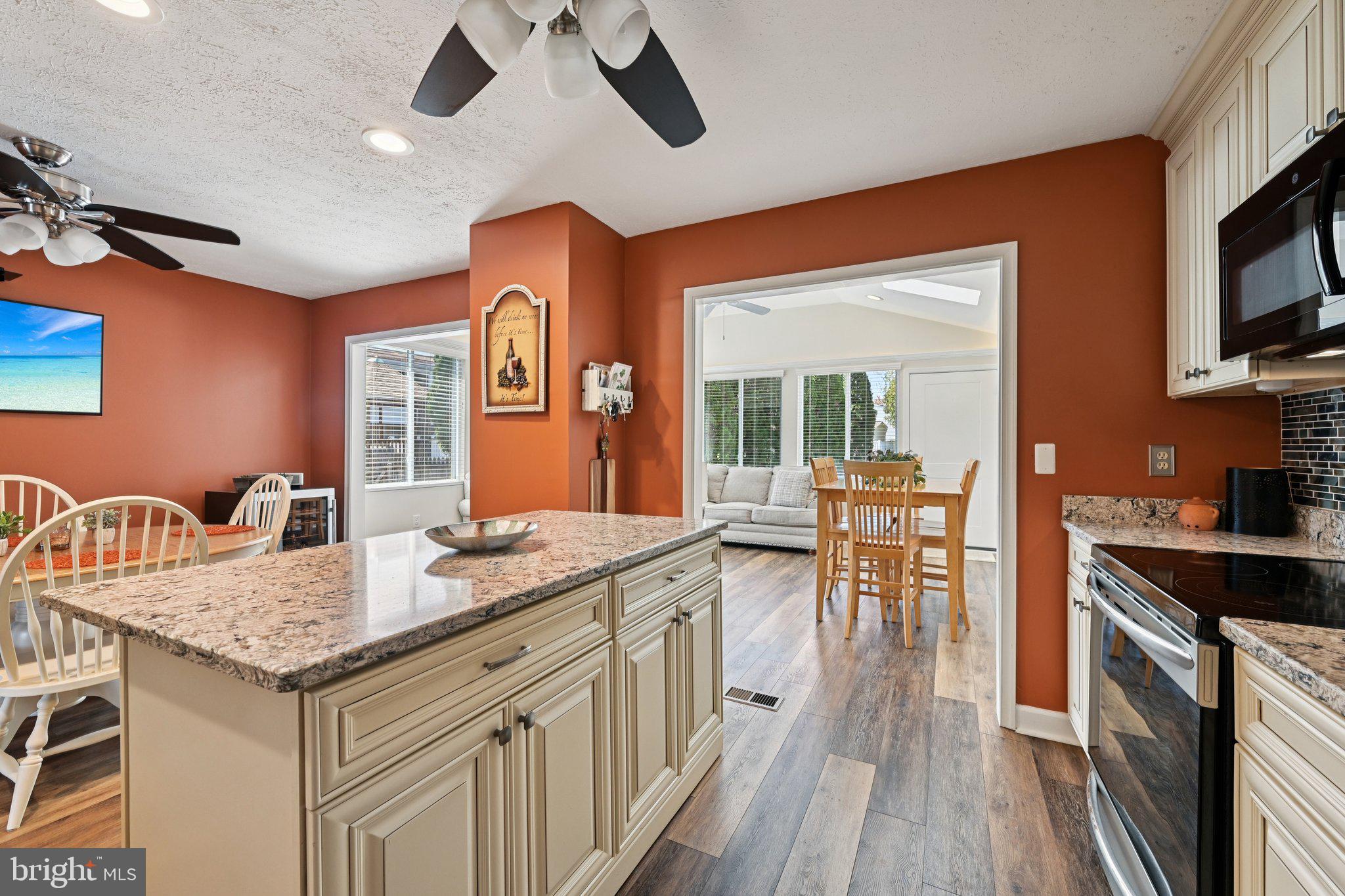 46 Bellfalls Way Baltimore, MD 21236 - Photo 27 of 65 a kitchen with granite countertop center island wooden floor and stainless steel appliances
