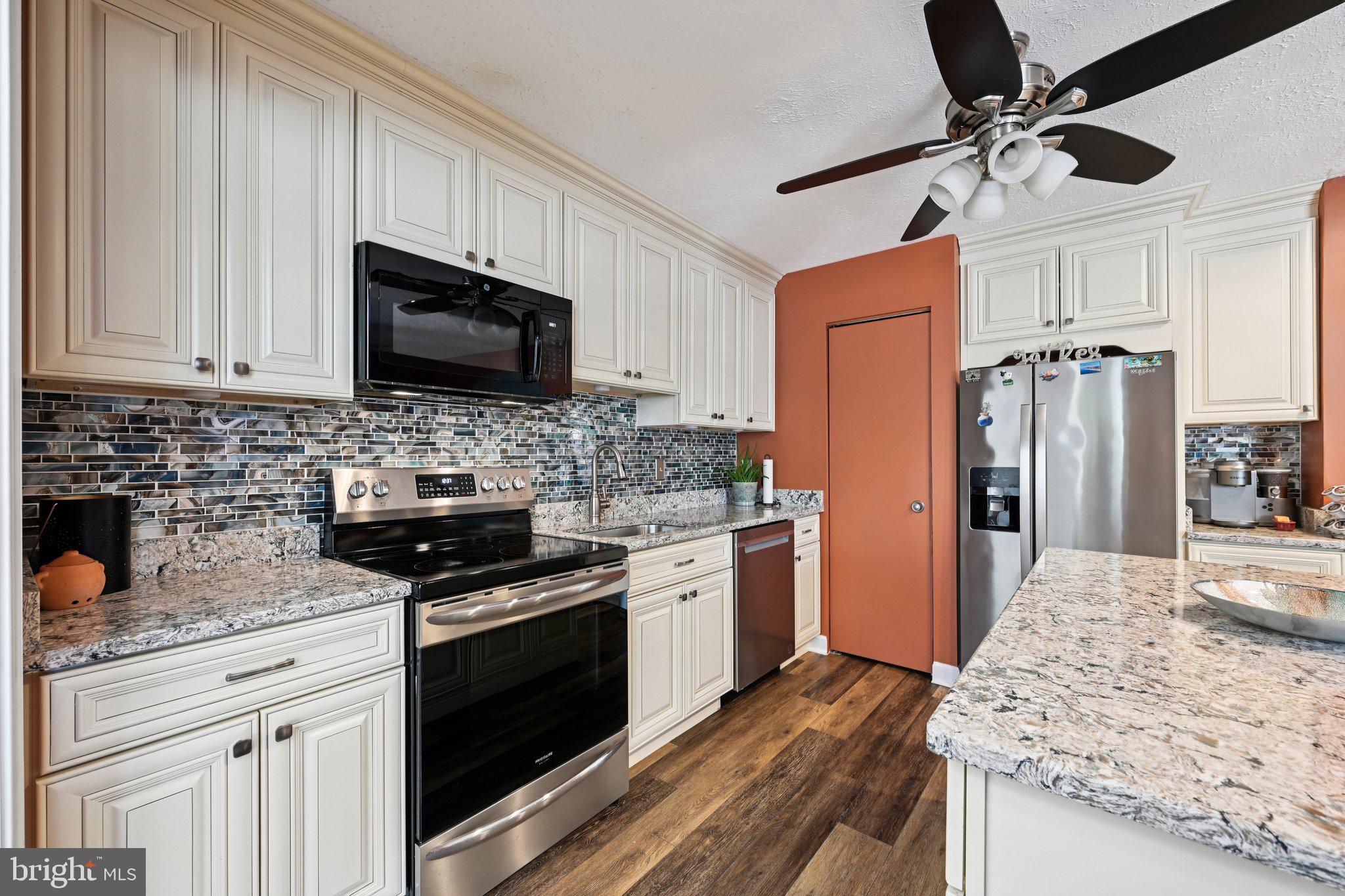 46 Bellfalls Way Baltimore, MD 21236 - Photo 29 of 65 a kitchen with stainless steel appliances granite countertop a stove refrigerator sink and microwave