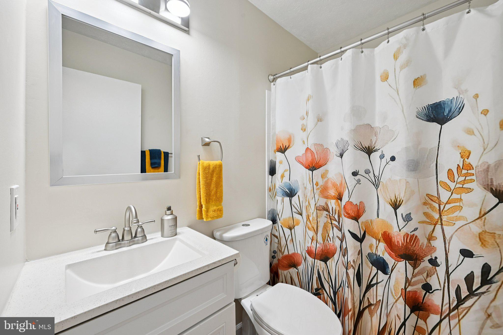 46 Bellfalls Way Baltimore, MD 21236 - Photo 34 of 65 a bathroom with a sink toilet and shower curtain