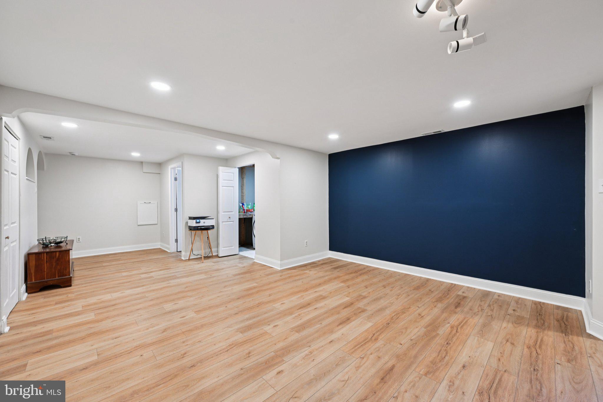 46 Bellfalls Way Baltimore, MD 21236 - Photo 45 of 65 a view of an empty room with wooden floor and a kitchen