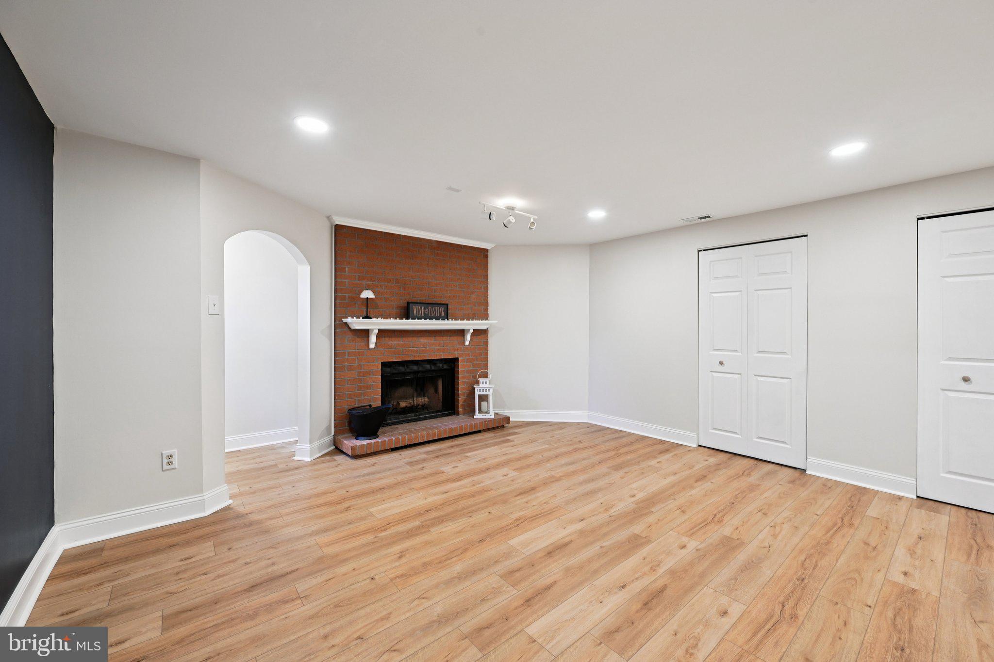 46 Bellfalls Way Baltimore, MD 21236 - Photo 47 of 65 a view of an empty room with wooden floor fireplace and a window