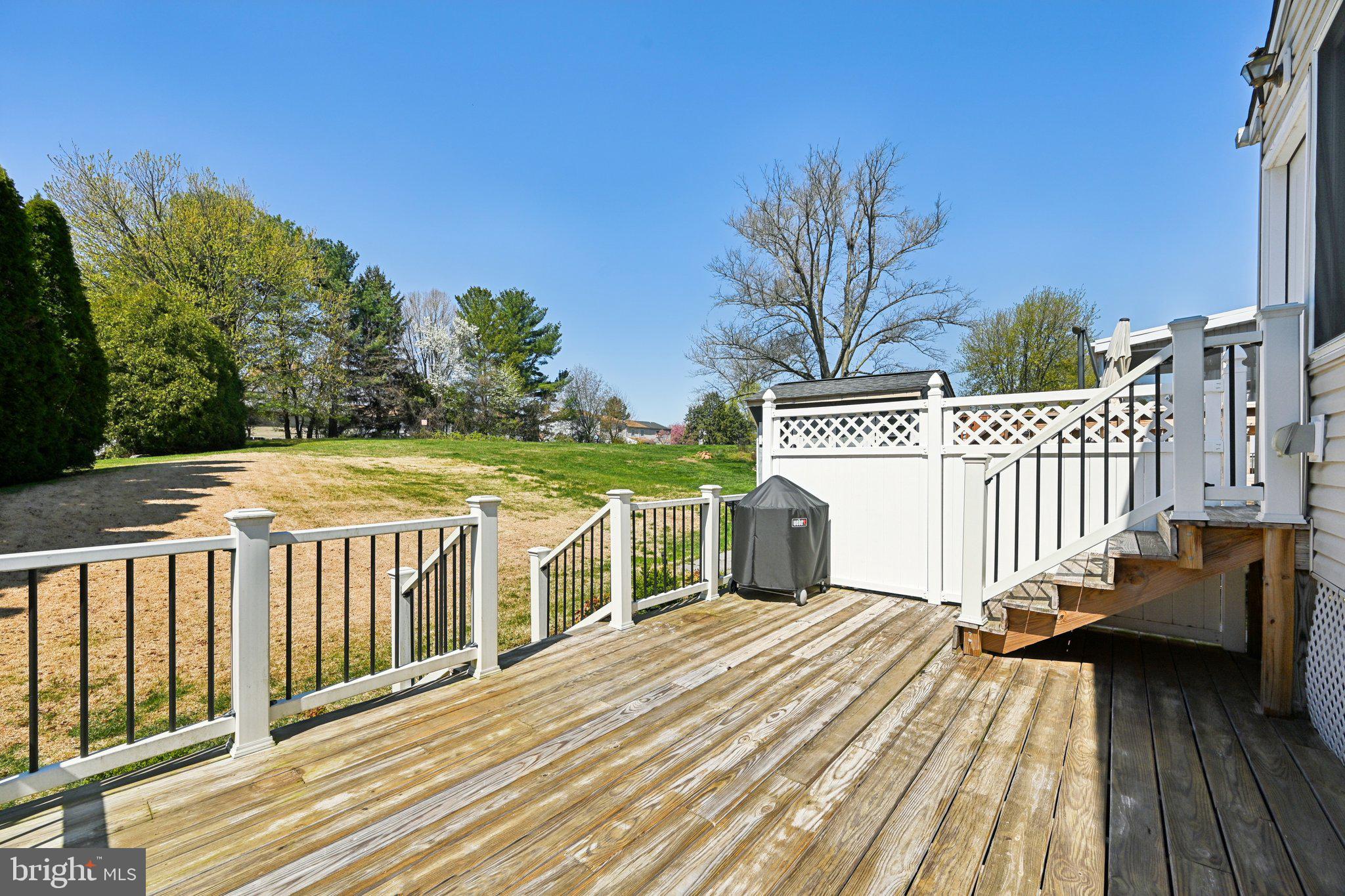 46 Bellfalls Way Baltimore, MD 21236 - Photo 55 of 65 a view of a deck with wooden floor and fence next to a yard