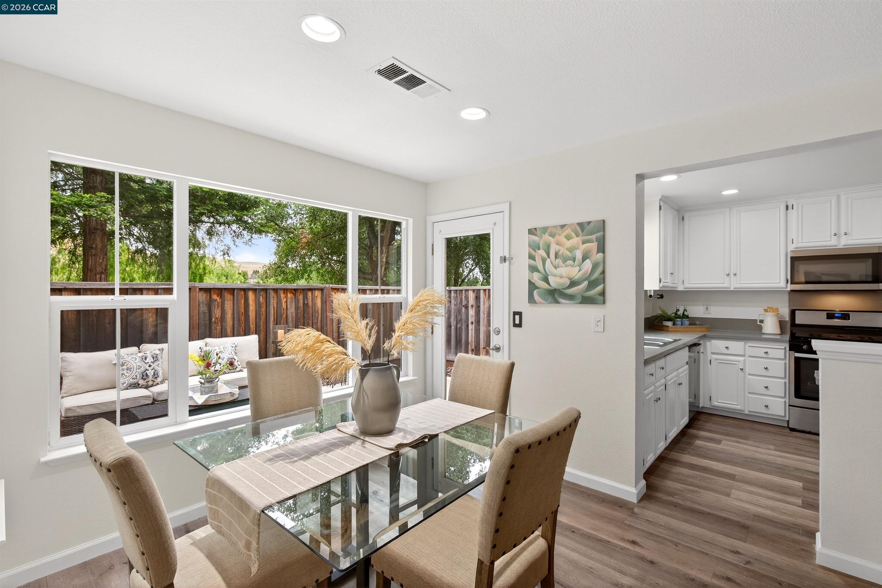 124 Coralflower Lane San Ramon, CA 94582 - Photo 9 of 47 a view of a dining room with furniture large windows and wooden floor